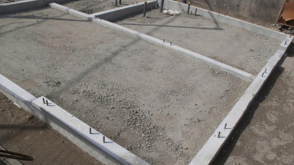 Concrete foundations being laid for a carport