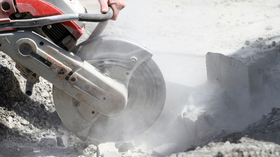 Concrete contractor using a disk cutter to repair a concrete floor