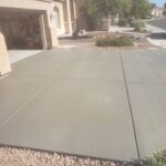 A concrete driveway with a car in front of it provided by Scottsdale Concrete Solutions.