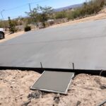 An expansive concrete slab in the desert with a truck on it, showcasing Scottsdale concrete solutions.