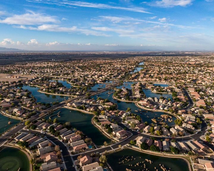 An aerial view of a residential neighborhood in Arizona with concrete sidewalks scattered throughout.