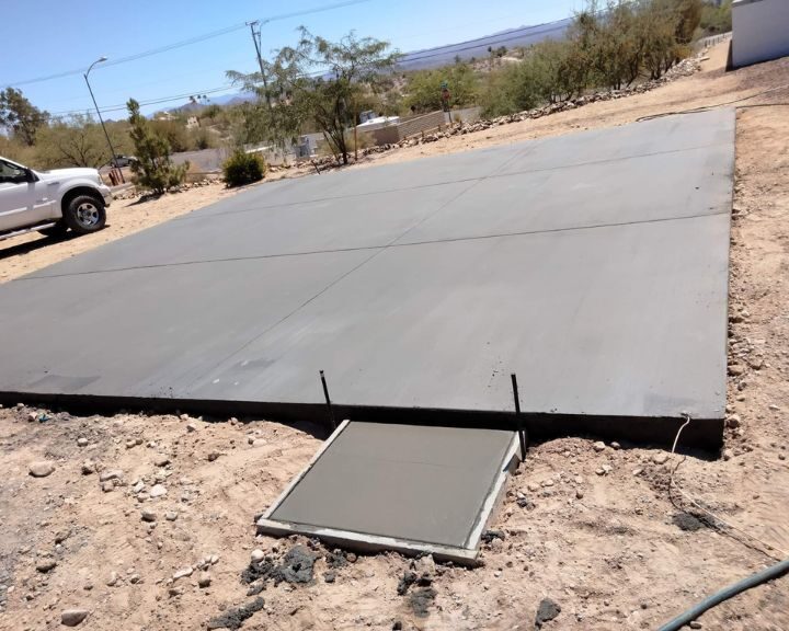A concrete slab on a dirt road in Arizona, suitable for use as a concrete driveway or concrete sidewalk.