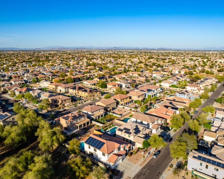 An aerial view of a residential neighborhood in Arizona with concrete driveways and possibly concrete patios.