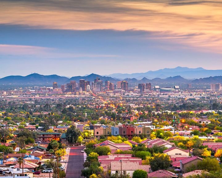 The skyline of Phoenix, Arizona at sunset overlooking a concrete patio.