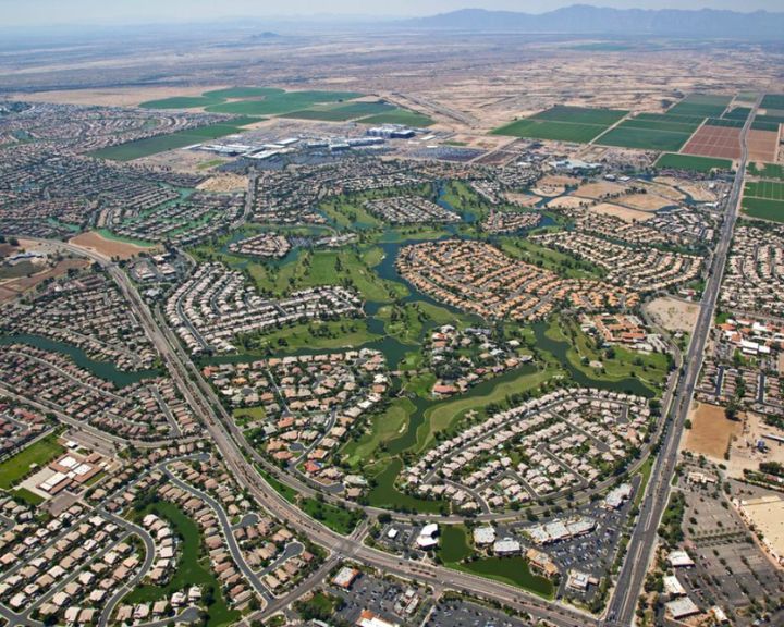 An aerial view of a town in Arizona showcasing concrete driveways and concrete sidewalks.