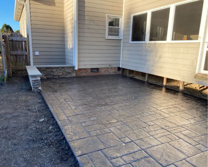 A stamped concrete patio in a backyard created by Scottsdale Concrete Solutions.